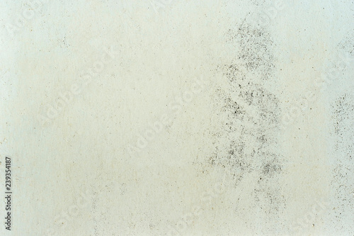 White wall with a beige yellowish color with a rough texture and a faded wash to the concrete. Background