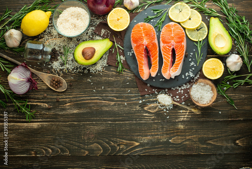 Fresh fish steak trout, salmon, salmon, red fish meat. With ingredients and vegetables on a wooden background, Flat-lay, Clean and healthy food