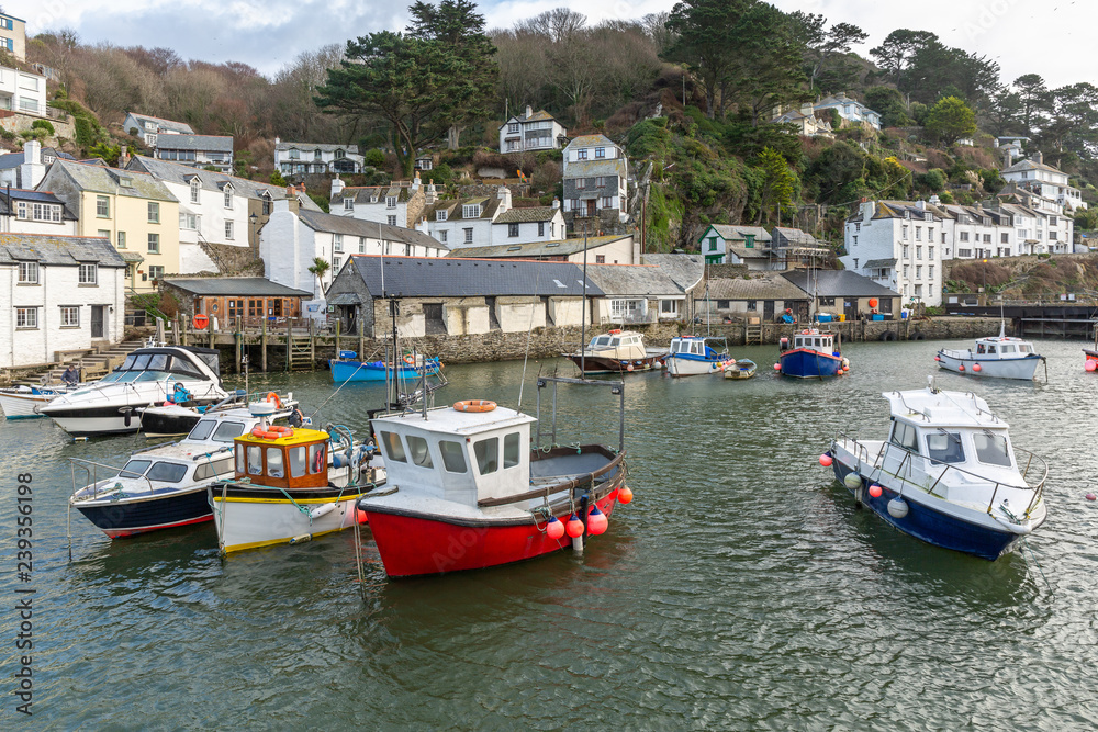 Boats moored in the historic harbour at Polperro in Cornwall, UK