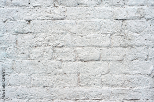 Brick wall painted with white paint with drawing the texture of bricks. Background