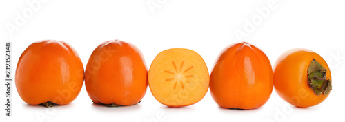 Ripe persimmons on white background