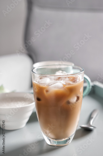 Glass of tasty frappe coffee on table