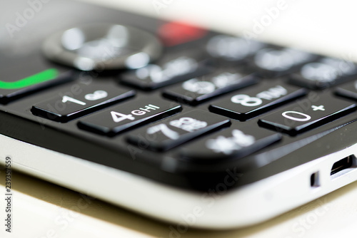 Mobile phone keypad close up macro shot, shallow depth of field, image for background. © Alpar