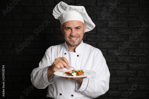Male chef with tasty salad ...