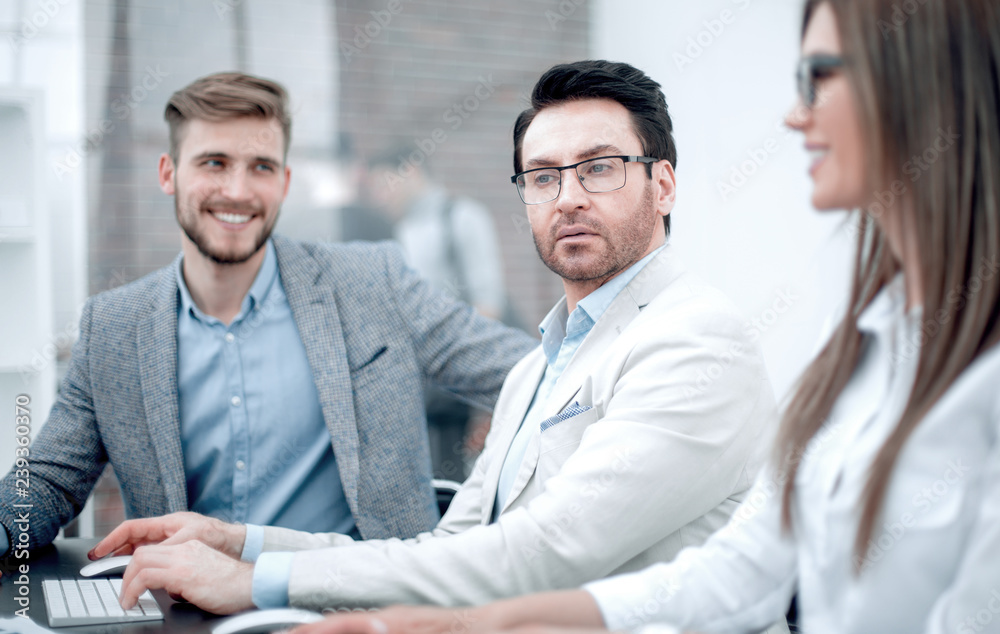 close up.businessman and employees sitting at the Desk close up.businessman and employees sitting at the Desk