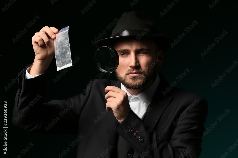 Detective processing evidence on dark background Detective processing evidence on dark background