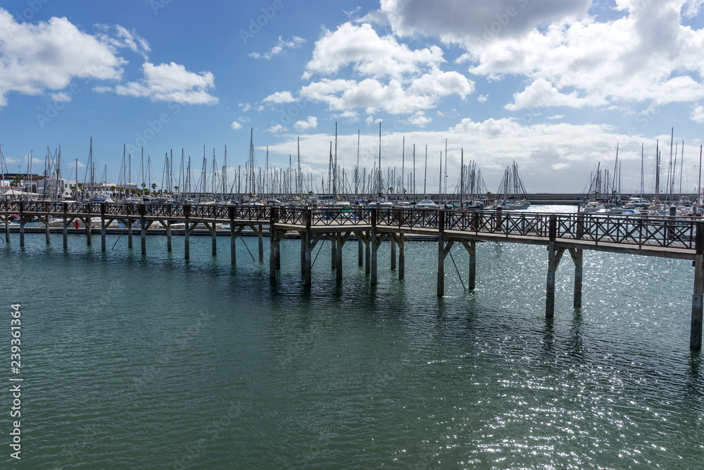 Wooden bridge at the boat harbor of Marina Rubicon in Playa Blanca. Lanzarote. Canary Island. Spain