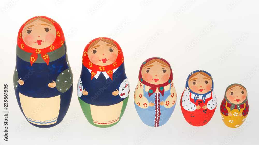 Set of Russian dolls babushka matryoshka lined up isolated on white