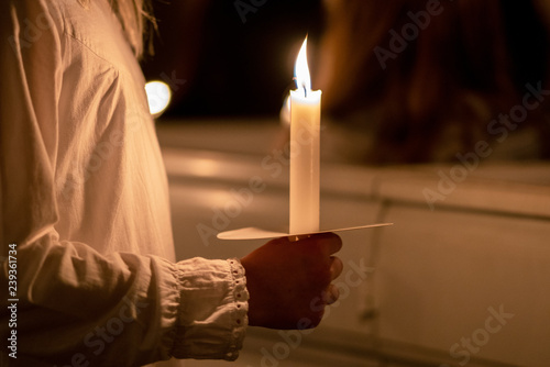 People handling candles in the hands. Christmas and lucia holidays in Sweden photo