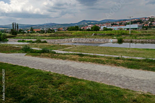 Landscape of Residential district and river valley Bregalnica with place for relax and trees, town Delchevo among Maleshevo and Osogovo mountains, Macedonia, Europe 