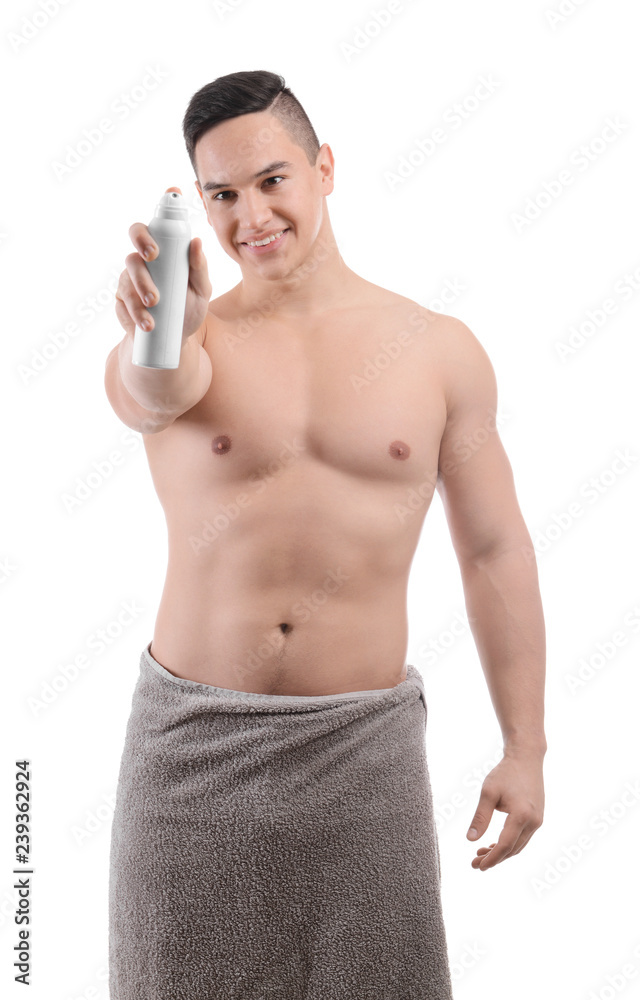 Fototapeta premium Young man with deodorant on white background