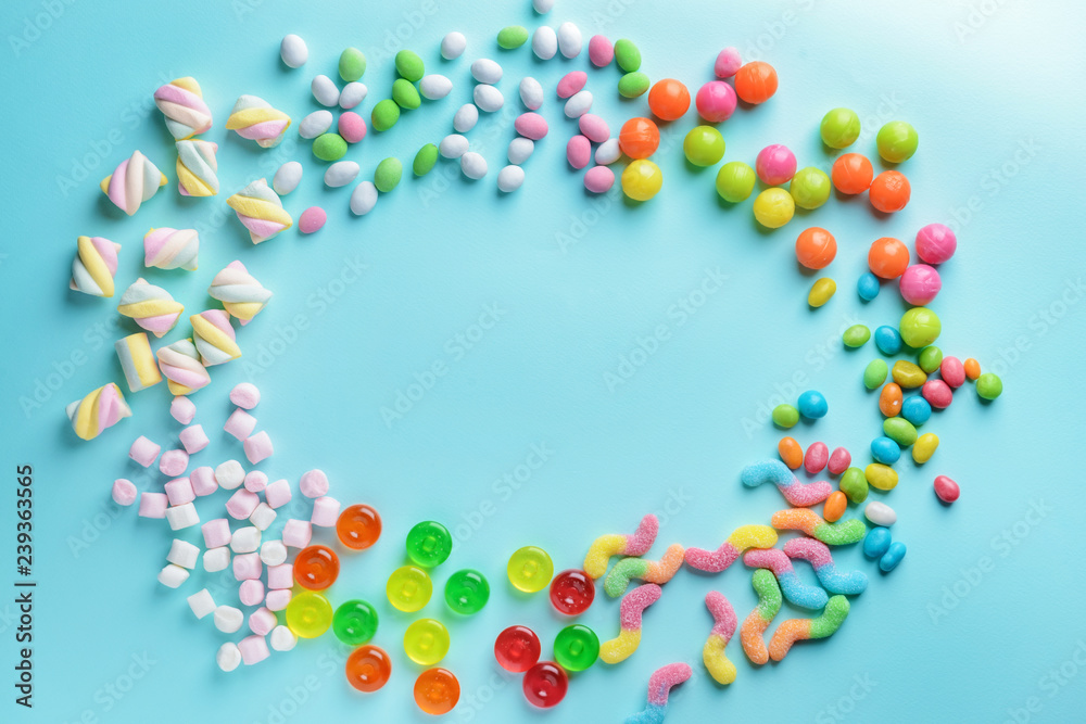 Frame made of tasty sweets on color background Frame made of tasty sweets on color background