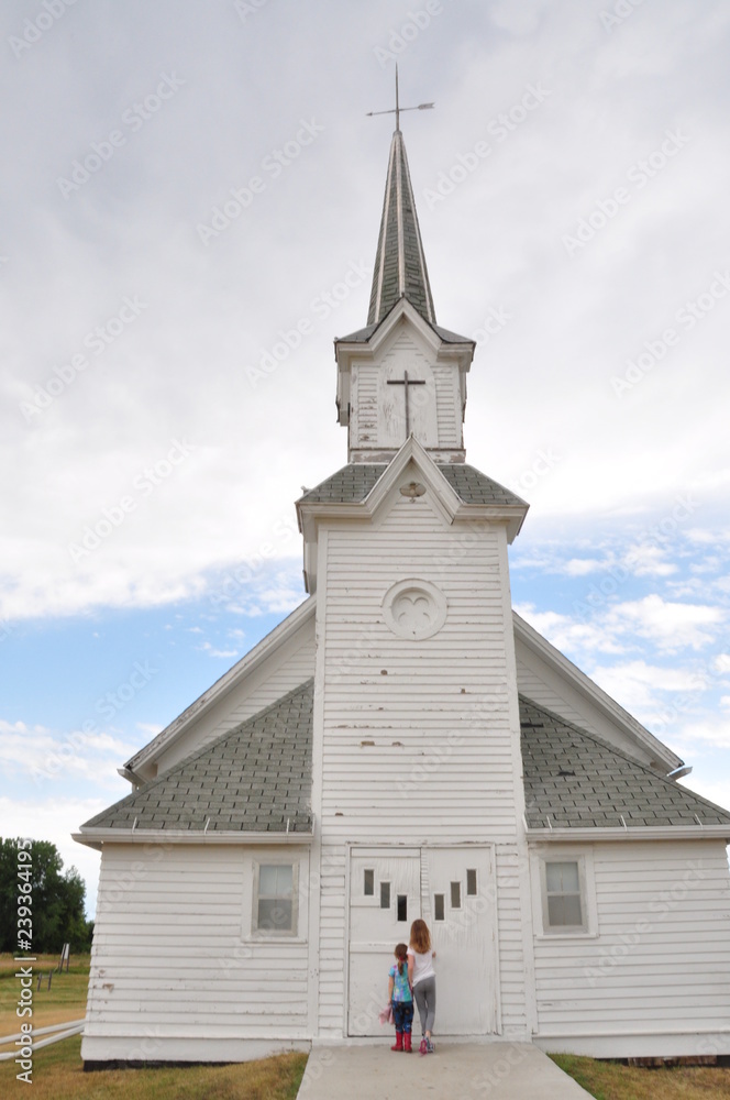 Two Little Girls Standing Outside of Small Town Church, South Dakota