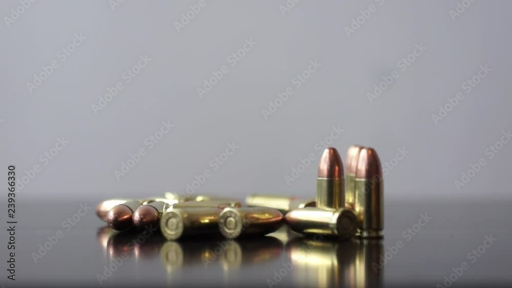 9mm bullets on table Dolly macro shot of 9mm bullets on table 9mm bullets on table Dolly macro shot of 9mm bullets on table