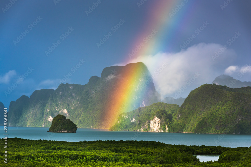 A rainbow appears over the island of Phuket. This ocean of India tropical island is one of the most beautiful in the world.