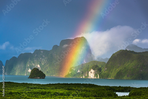 Obraz na płótnie A rainbow appears over the island of Phuket. This ocean of India tropical island is one of the most beautiful in the world. w salonie