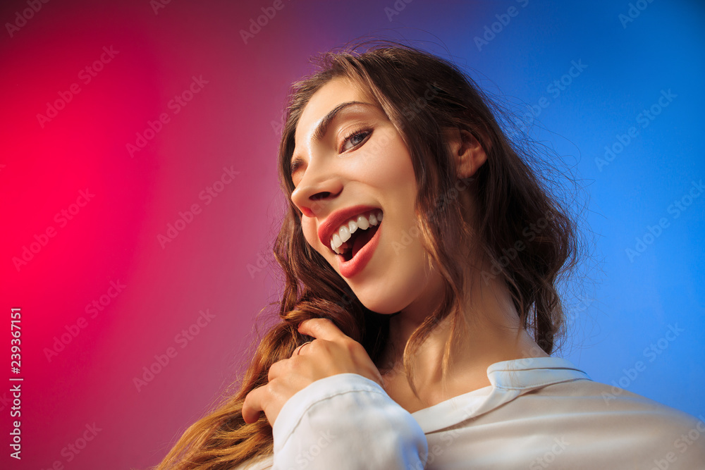 Happy woman standing, smiling on colored studio background. Beautiful female half-length portrait. Young satisfy woman. Human emotions, facial expression concept. Happy woman standing, smiling on colored studio background. Beautiful female half-length portrait. Young satisfy woman. Human emotions, facial expression concept.