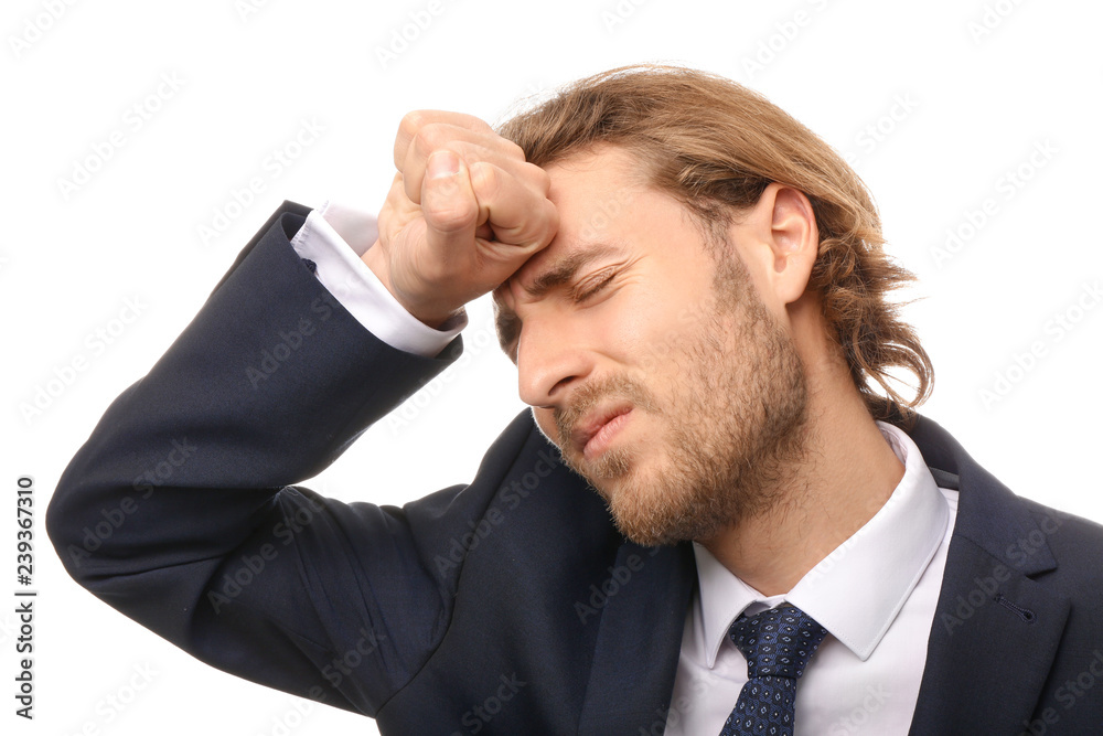 Young businessman suffering from headache on white background Young businessman suffering from headache on white background