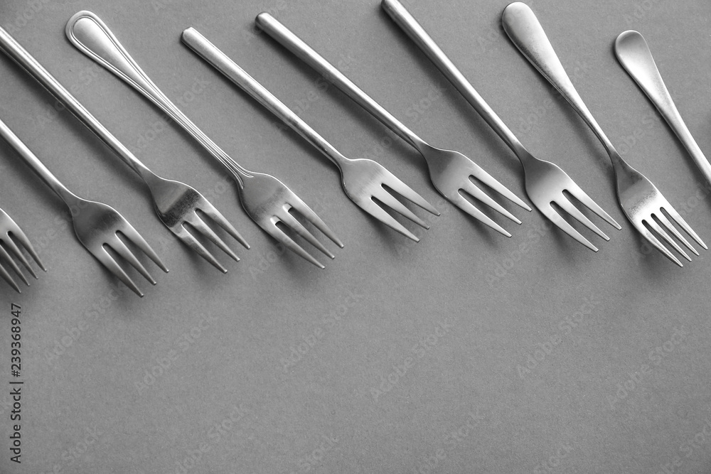 Set of forks on grey background Set of forks on grey background