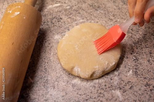 Child shaping and cutting baking cookies for christmas