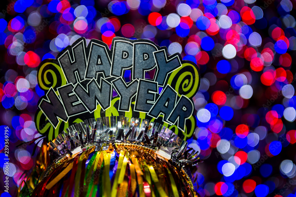Obraz premium Happy New Year party hat sparkling against a glowing holiday celebration background in a colorful bokeh lights night view