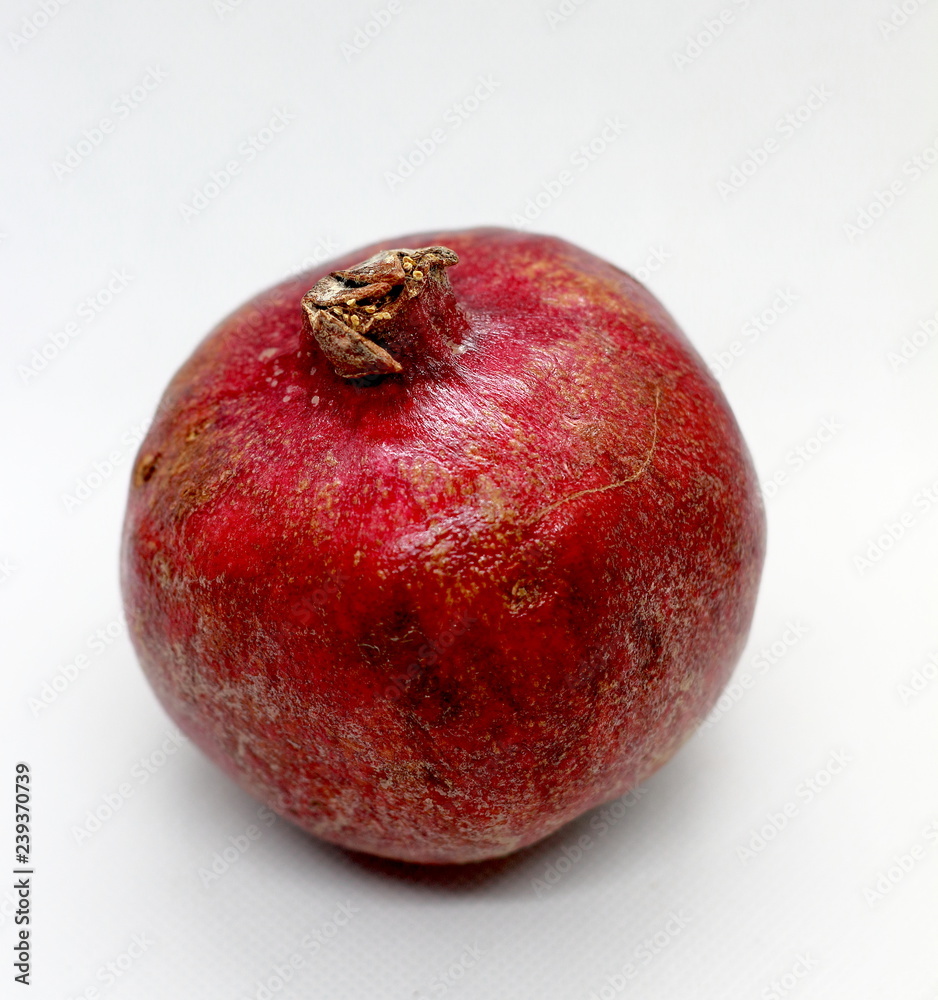 Ripe organic pomegranate on white background. Close up big fresh pomegranate fruit. Ripe organic pomegranate on white background. Close up big fresh pomegranate fruit.