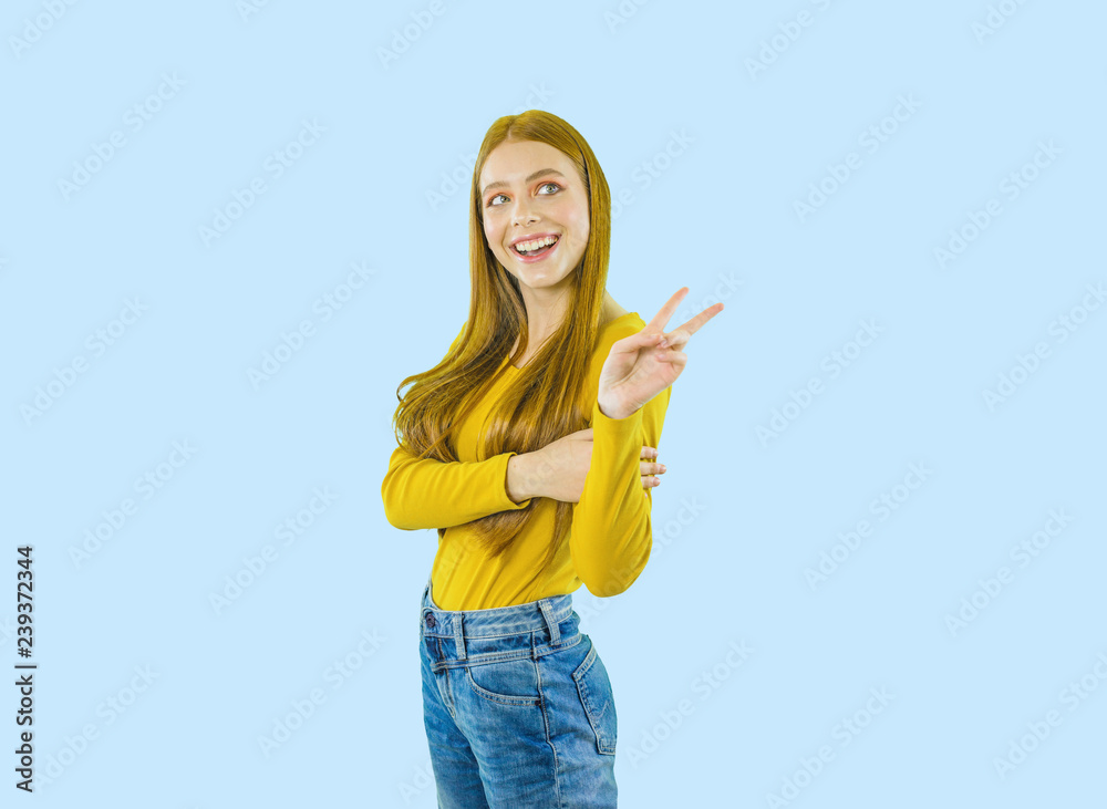 Portrait of a young beautiful red-haired woman standing in profile looking to the side and showing piss, shooting on an isolated background Portrait of a young beautiful red-haired woman standing in profile looking to the side and showing piss, shooting on an isolated background
