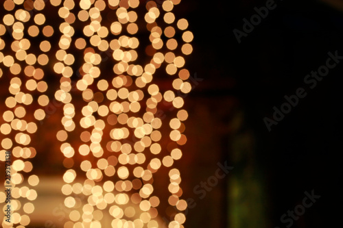 Blurred abstract background with golden glittering christmas lights.