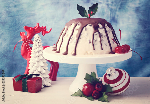 Tablou pe pânză Summertime Christmas Ice Cream Plum Pudding on white cake stand with reindeer and ornaments, with applied retro film filter
