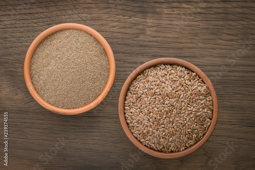 Flax seeds and ground seed in earthenware bowls