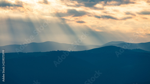 Beautiful sunset rays falling on top of a valley in Buila Vanturarita mountains, Romania © Andrei