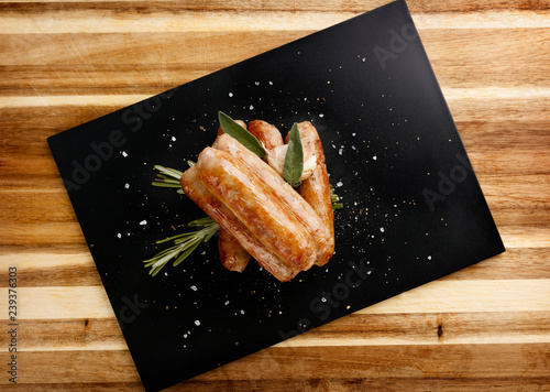 Plan view of  seasoned tastey sausages with a garlic and herb garnish photo