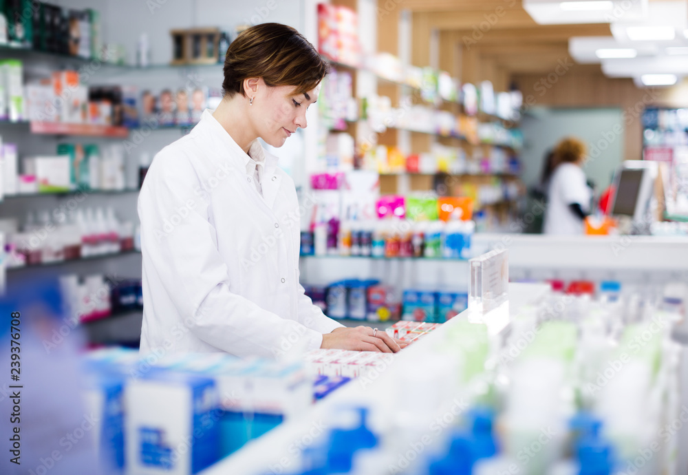 Pharmacist organizing assortment of care products