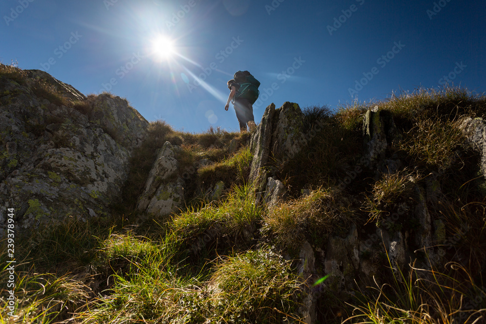 Girl hiking through Fagaras mountains in Romania.