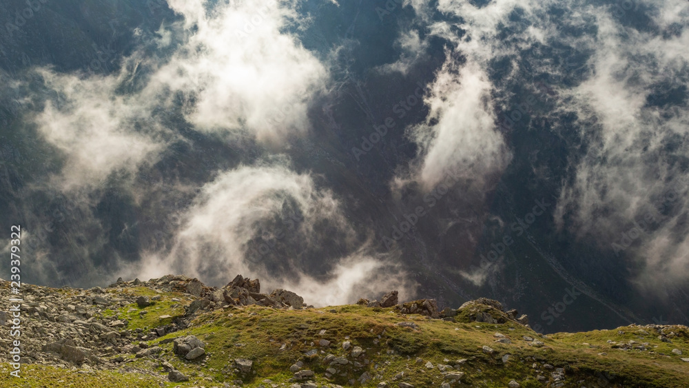 Summer day with dense fog in Fagaras mountains in Romania