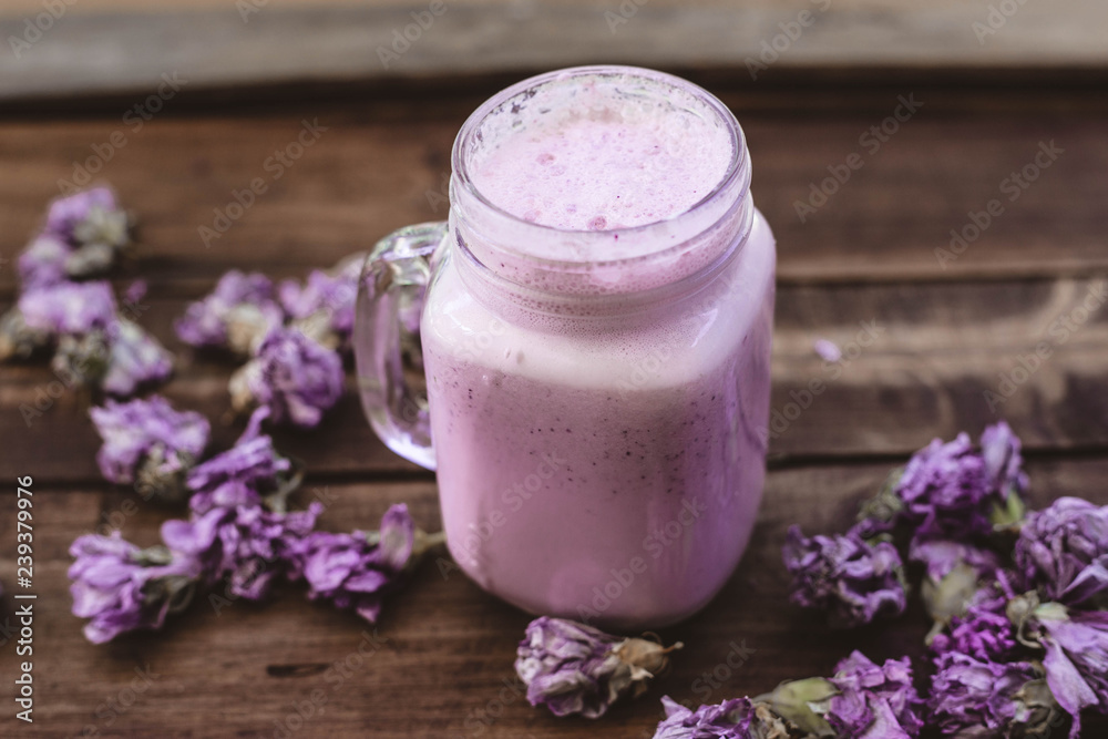 cranberry smoothie with dried flowers on a wooden table cranberry smoothie with dried flowers on a wooden table