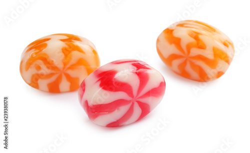 Different delicious colorful candies on white background