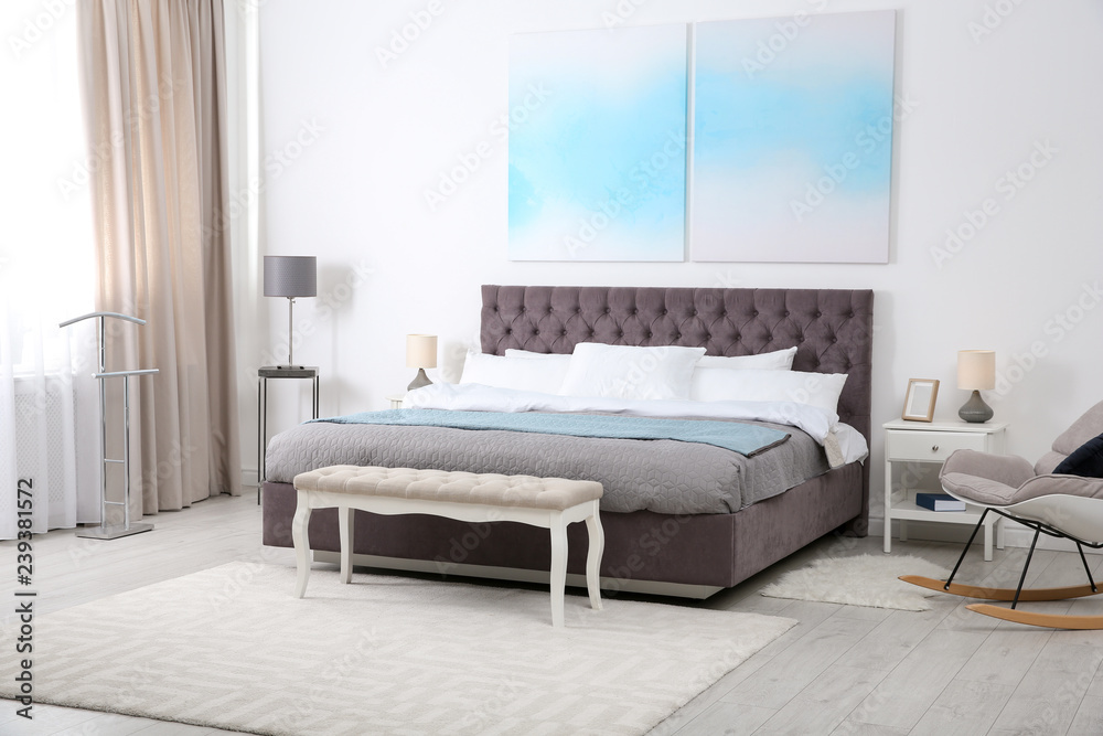 Stylish room interior with large comfortable bed Stylish room interior with large comfortable bed