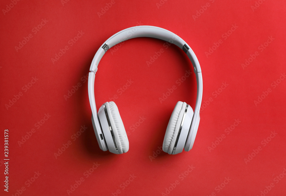 Wireless headphones on color background, top view Wireless headphones on color background, top view