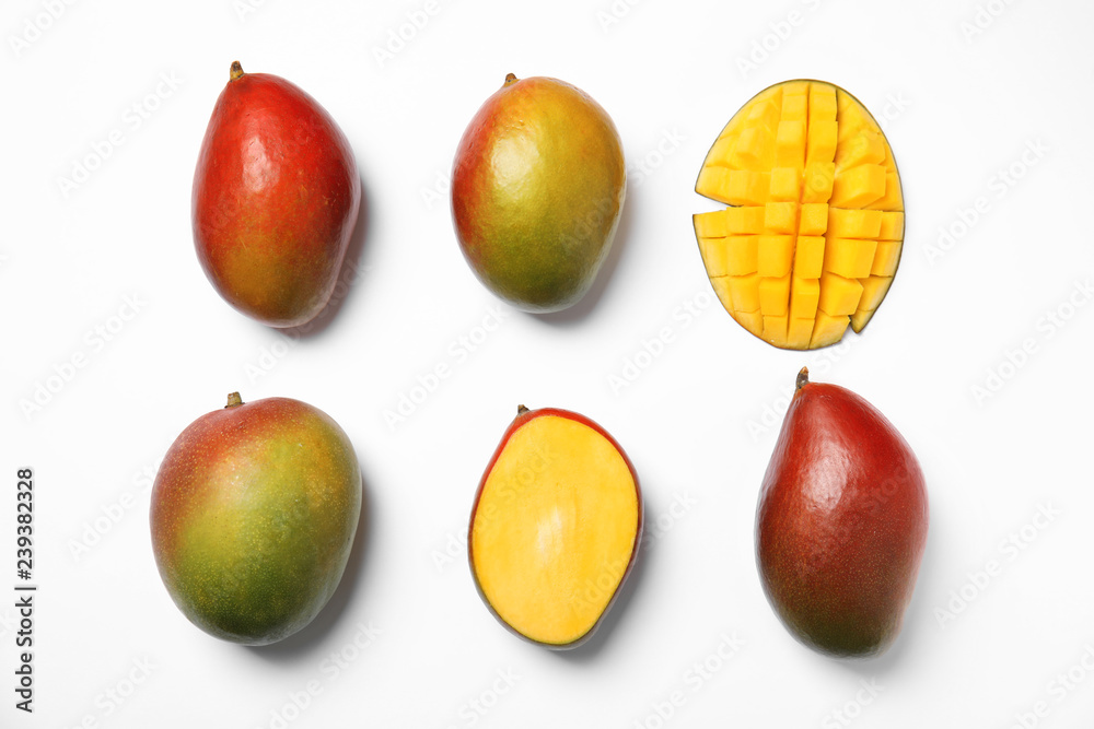 Tropical cut and whole mango fruits isolated on white, flat lay