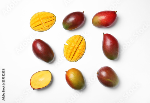 Tropical cut and whole mango fruits isolated on white, flat lay