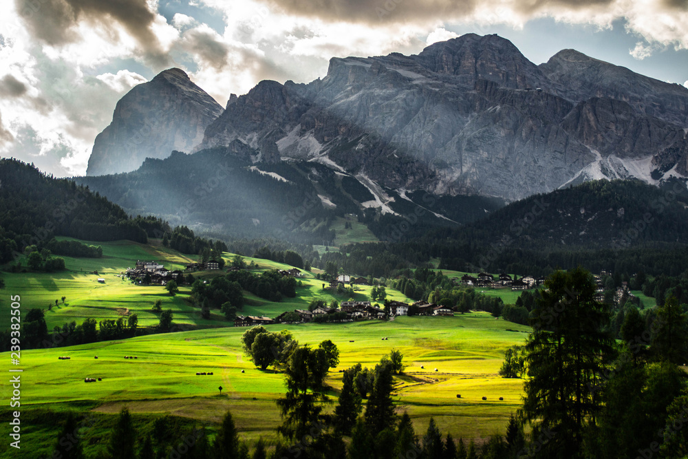 Scenic landscape panoramic view of Cortina D´Ampezzo and Tofana mountains, highest peaks in Dolomites, Italy. Popular tourist destination/attraction for active family holiday. Summer warm colours