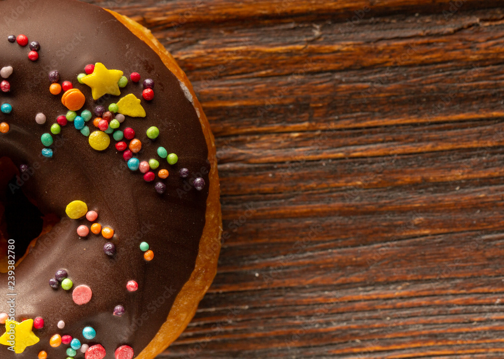 Fresh donut served on the old wooden table with a clearly visible texture Fresh donut served on the old wooden table with a clearly visible texture