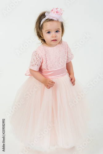 Pretty little girl in pink dress. small princess. kid fashion and beauty. Happy birthday. New year party. small girl child. Christmas. happy childhood of little girl. Kid shopping