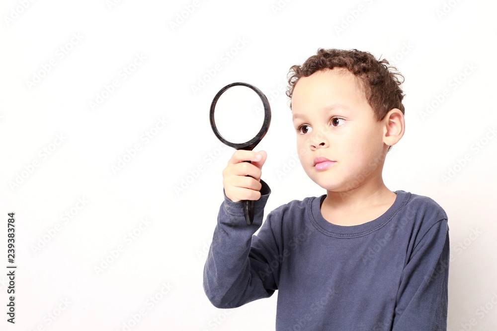 young boy with magnifying glass ready to explore young boy with magnifying glass ready to explore