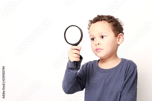young boy with magnifying glass ready to explore