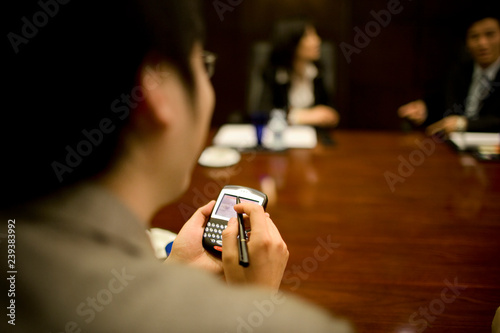 Notes being taken on a phone on a boardroom. photo