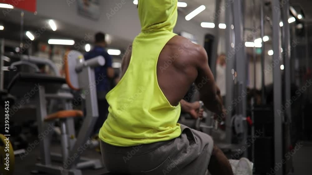 African american man making exercice on training apparatus in gym