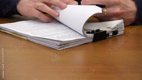 The index finger moves through the text in the document.