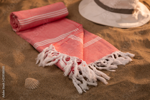 Handwoven hammam Turkish cotton towel on beach